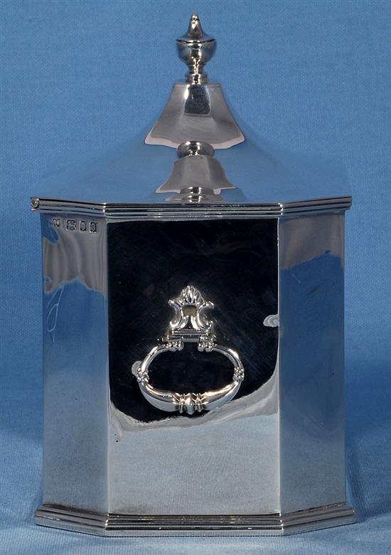 A George V silver two handled octagonal tea caddy, by Richard Comyns, length 202mm, weight 27.1oz/845grms.